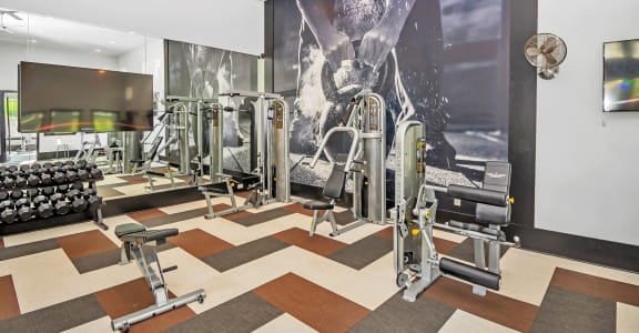 a workout room with a large picture of a man on the wall