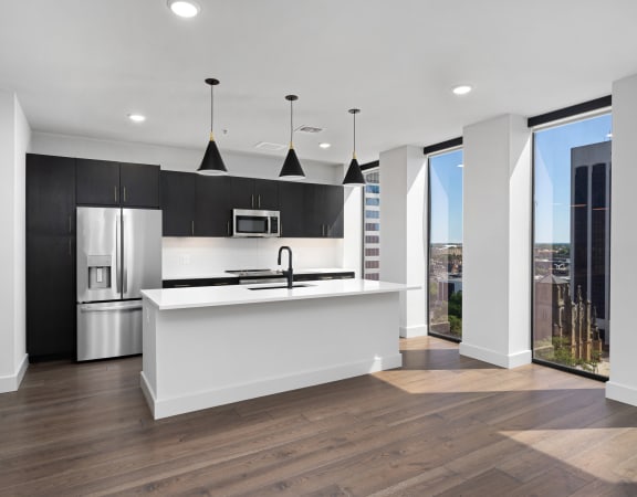 a kitchen with white countertops and black cabinets at Preston Centre, Columbus, OH