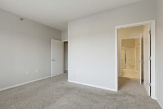 Master bedroom with walk-in closet and private bath Master bedroom with walk-in closet and private bath at Waterstone Place, Minnetonka, MN, 55305