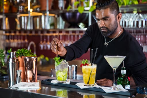 a bartender making cocktails in a bar