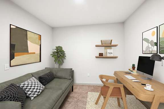 A living room with a couch, a desk, and a painting on the wall