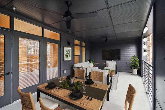 a living room with a wooden table and chairs and a television