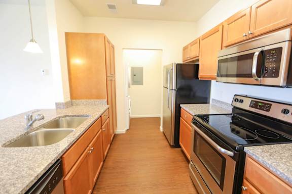 A kitchen with wooden cabinets and stainless steel appliances.