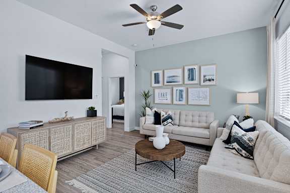 an open living room with couches and a tv