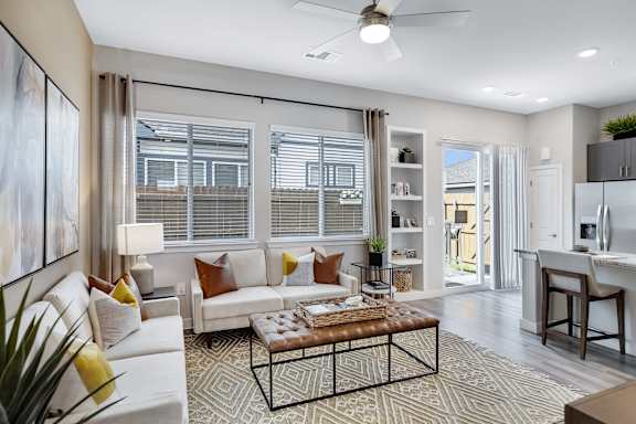 A living room with a white couch and a coffee table.