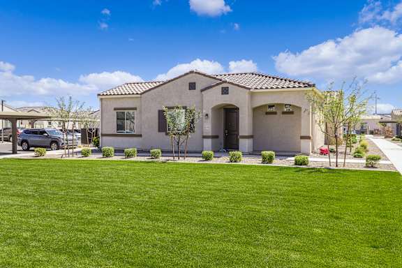 a house with a green lawn in front of it