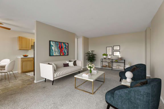 a living room with a couch and chairs and a coffee table