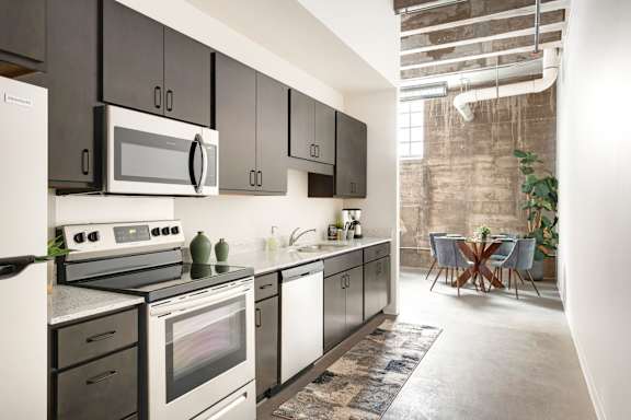 a kitchen with stainless steel appliances and black and white cabinets