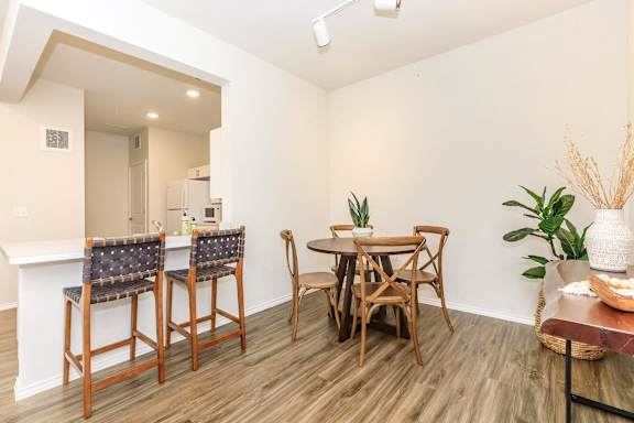 a dining room with a table and chairs and a kitchen at Hazelwood Place Apartments, Princeton