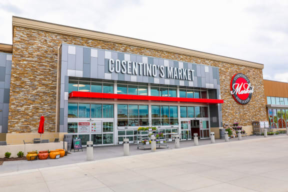 a business incentives market building with a sign on the side of it at The Residences at Bluhawk Apartment Homes, Overland Park, 66085