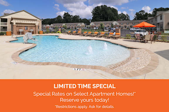 A pool with a sign offering a limited time special of 2 months free with a 13 month lease.