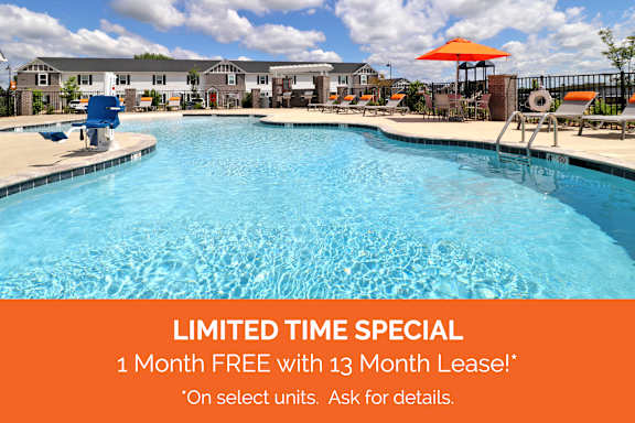 A pool with a sign offering a free month with a 13 month lease.