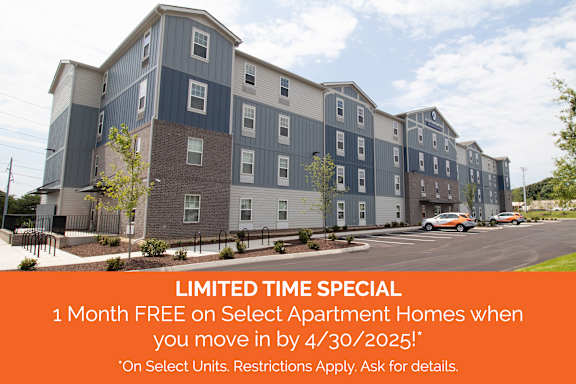 Apartment complex with a sign offering a free month if you move in by a certain date.