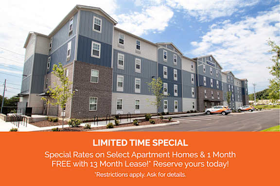 Apartment complex with a sign offering a free month if you move in by a certain date.