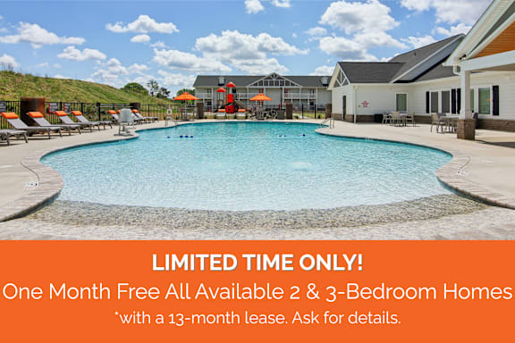 A pool surrounded by lounge chairs and umbrellas with a sign offering free one month leases for 2 and 3 bedroom homes.