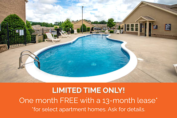 A pool with a sign offering a free month with a 13-month lease for select apartment homes.