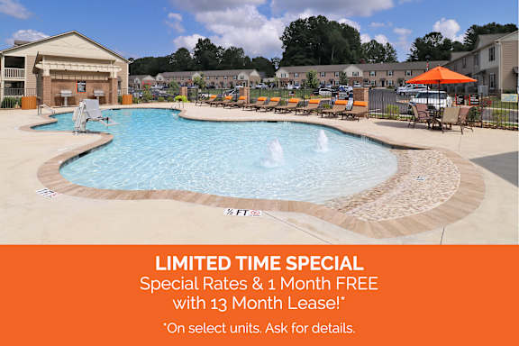 A pool with a sign offering a limited time special of 2 months free with a 13 month lease.