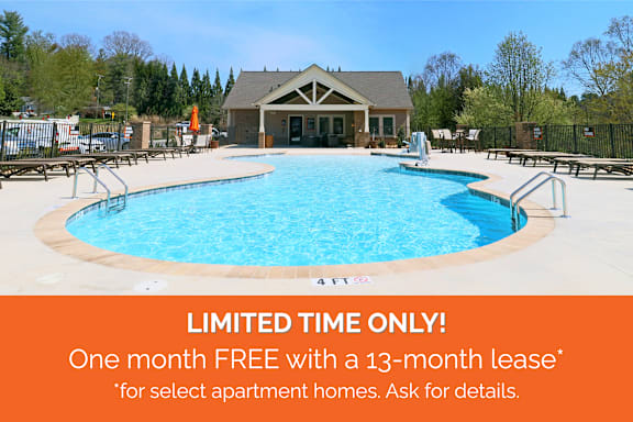 A pool with a sign offering a free month with a 13-month lease for select apartment homes.