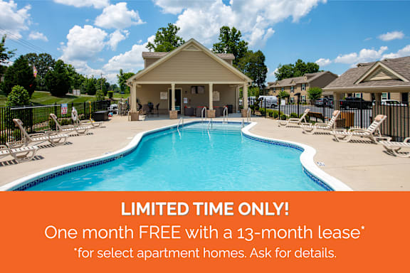 A pool and lounge area with a sign offering a free month with a 13-month lease.