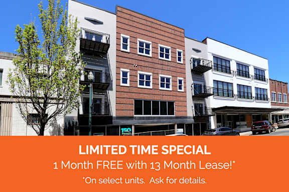 A building with a sign offering a free month with a 13 month lease.