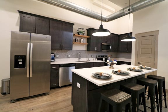 a kitchen with dark wood cabinets and white countertops