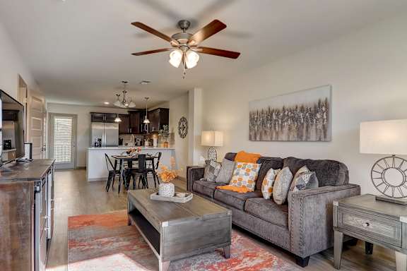 a living room and kitchen with a dining table