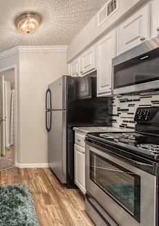 a kitchen with stainless steel appliances and marble counter tops at Highland Ridge Apartments, Overland Park , KS 66210