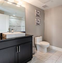 a bathroom with a toilet and a sink and a mirror