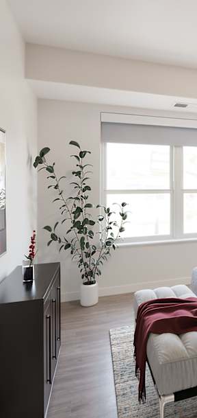 A bedroom with a large bed and a painting on the wall.