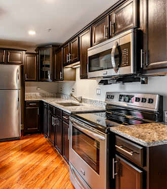 a kitchen with stainless steel appliances and granite counter tops