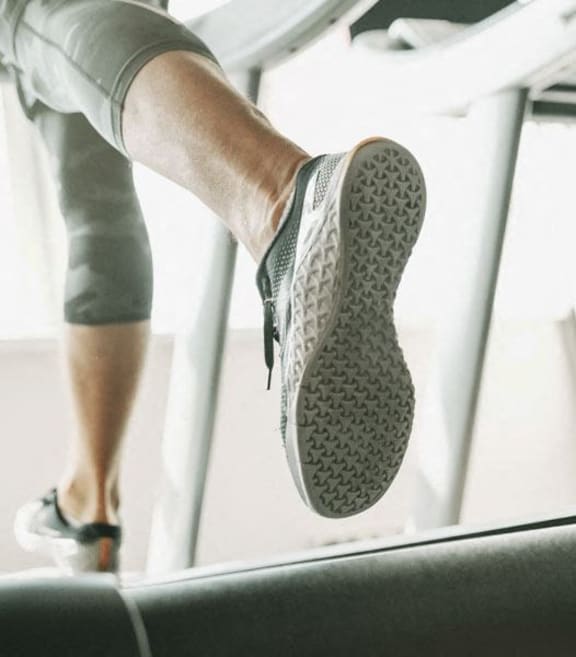 man running on a treadmill in a gym