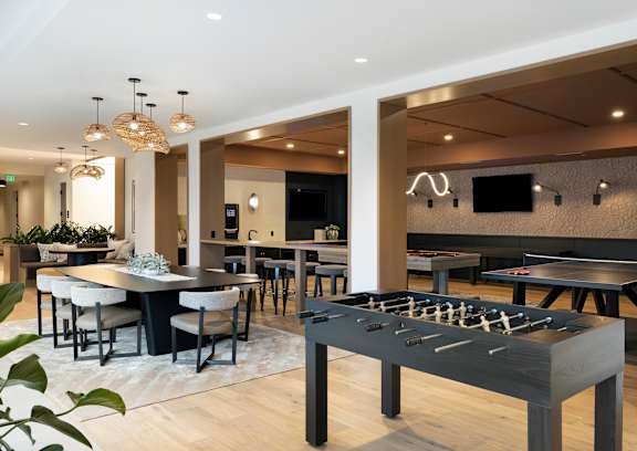A modern dining area with a long table and chairs.