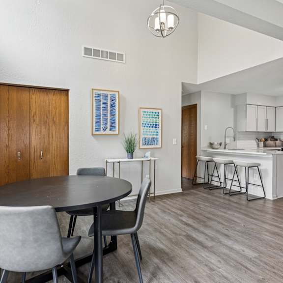 A kitchen with white countertops and cabinets.