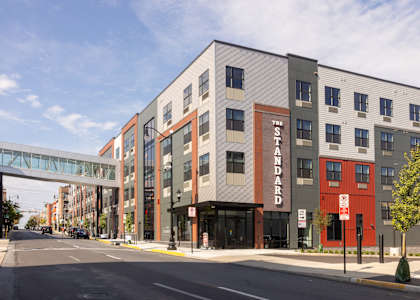 A street view of a building with the word "Standard" on it.