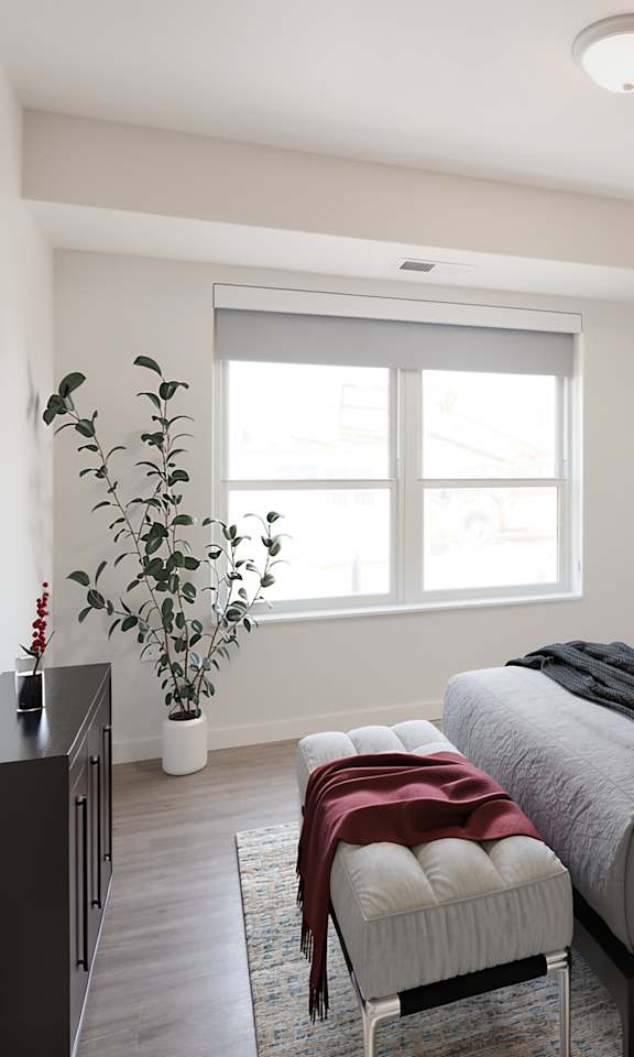 A bedroom with a large bed and a painting on the wall.