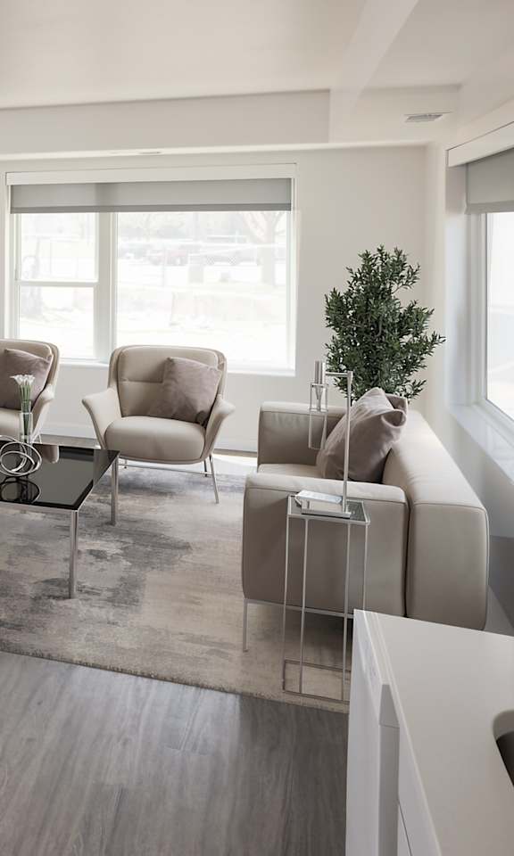 A modern living room with a wooden floor and furniture.