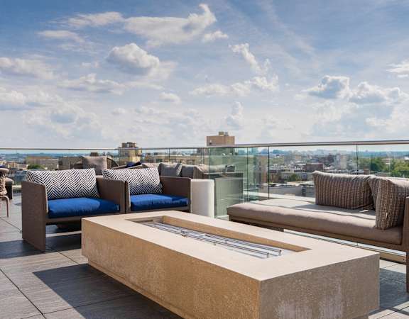 A modern outdoor seating area with a view of the city.