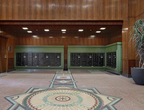 the lobby of a building with two vending machines and a rug in the floor