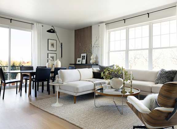 a living room with a white couch and a dining room table