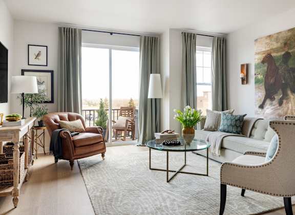 a living room with a couch and a chair and a table