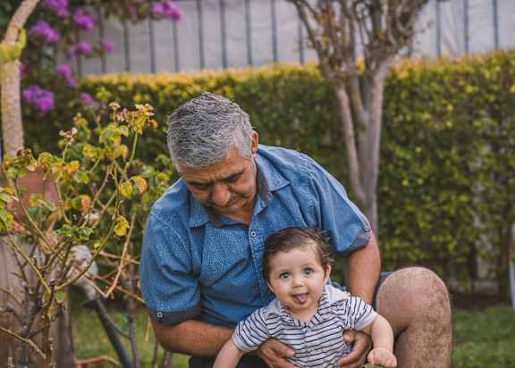 a man holding a baby in his lap