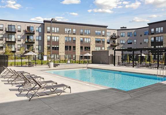 Terra's outdoor pool with chaise lounge chairs, cabanas, and an outdoor spa