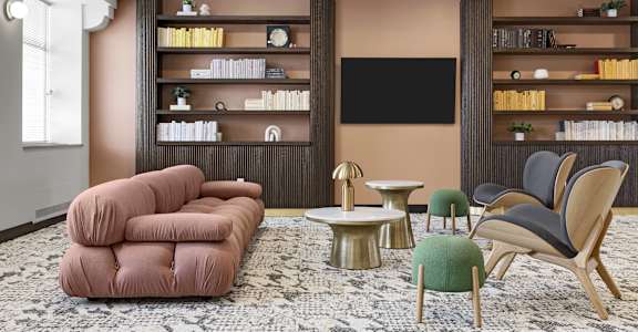 a living room with a couch and chairs and a television