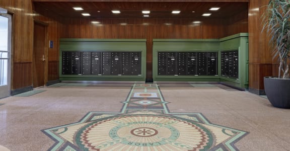 the lobby of a building with two vending machines and a rug in the floor