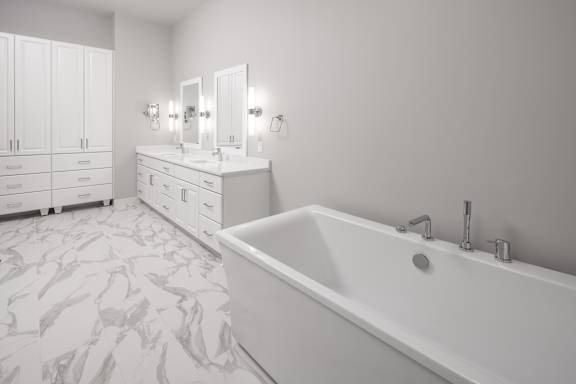 a large white bathroom with a tub and two sinks at Expo, Minneapolis, 55414