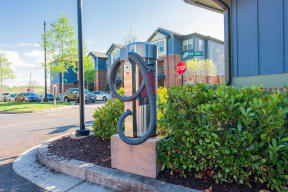 a sculpture in front of a building with a stop sign