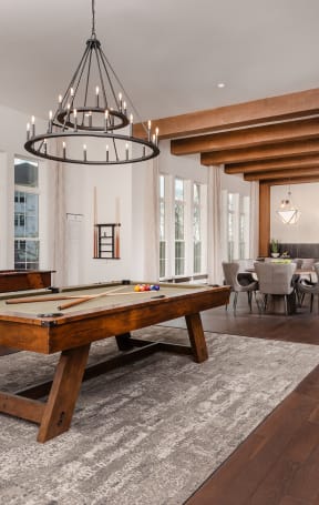 a large living room with a pool table and a dining room