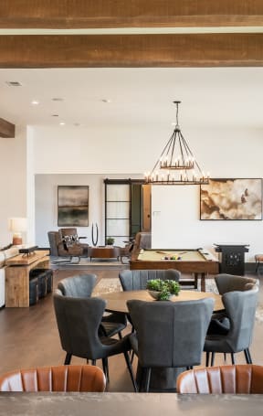 a dining room and living room with a table and chairs