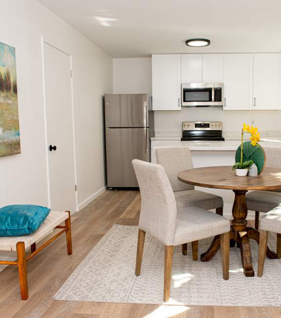 a kitchen and dining room with a table and chairs