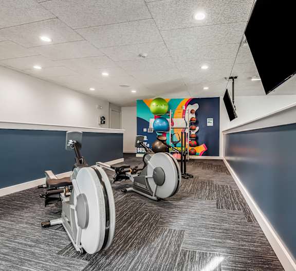 A room with a blue wall and a treadmill.